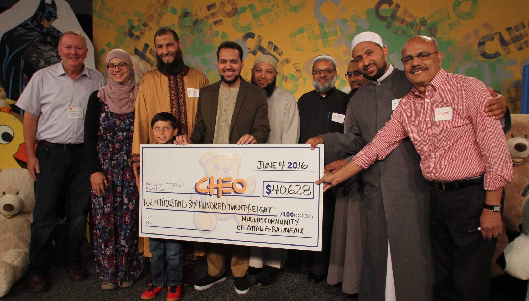 A group of people holding a cheque to CHEO